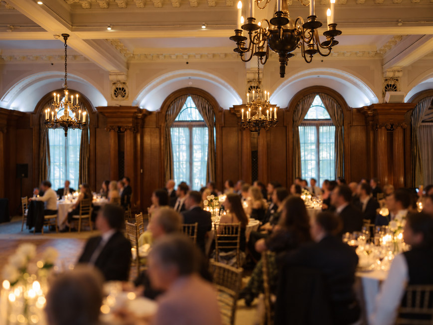 Guests gathered for dinner inside a warmly lit reception room